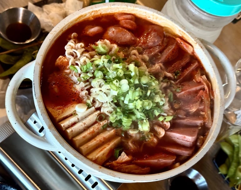 Gamamaru hot dish with sausage, spame, onions, and more © Scott Kendall